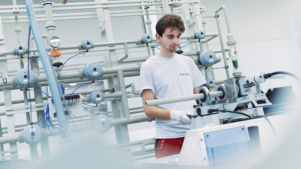 RENA employee at working station for professional plastics processing, assembly installation and quick services