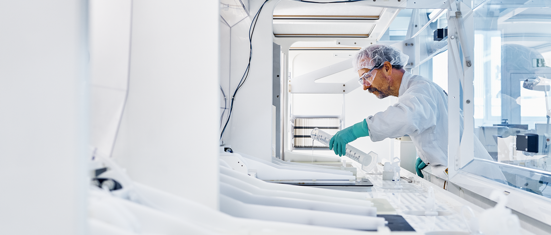 Innenansicht einer Weißen Maschine im Hintergrund ein RENA Mitarbeiter  Innenansicht einer Weißen Maschine im Hintergrund ein RENA Mitarbeiter