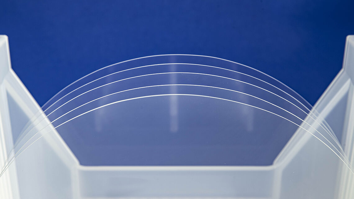 clear glass wafers in front of the blue background clear glass wafers in front of the blue background