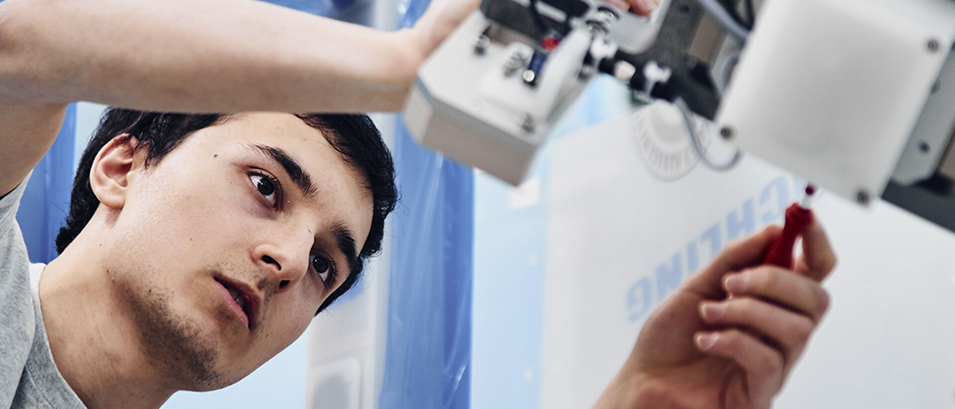 RENA employee working on a machine