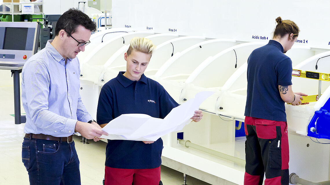 RENA employees in front of a machine during a planning phase